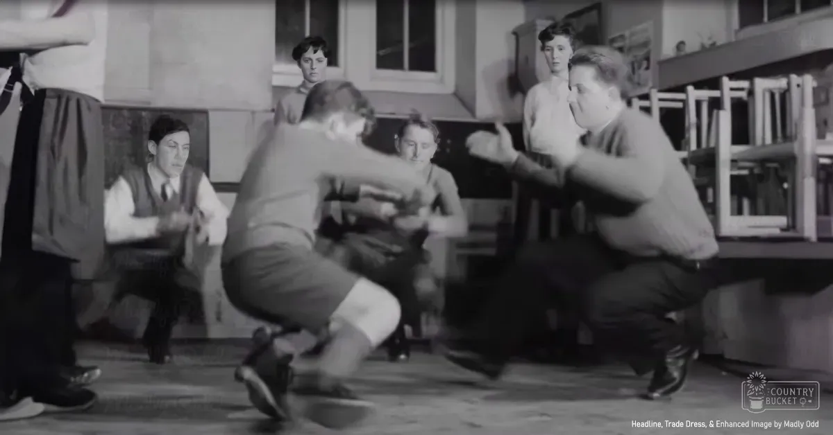 A dance scene indoors, likely from a mid-20th-century performance or theatrical production with simple decor and artificial lighting.