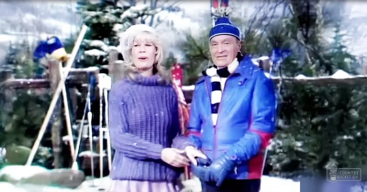 A middle-aged couple dressed in mid-20th century winter attire stands amidst a snowy park with skis leaning against a tree, surrounded by snow-covered trees and an overcast sky.