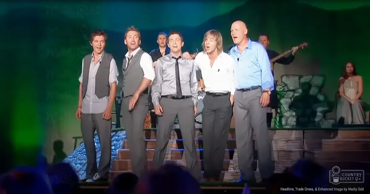 Group performance scene at an indoor concert or theater with adults in formal attire on stage under artificial lighting.