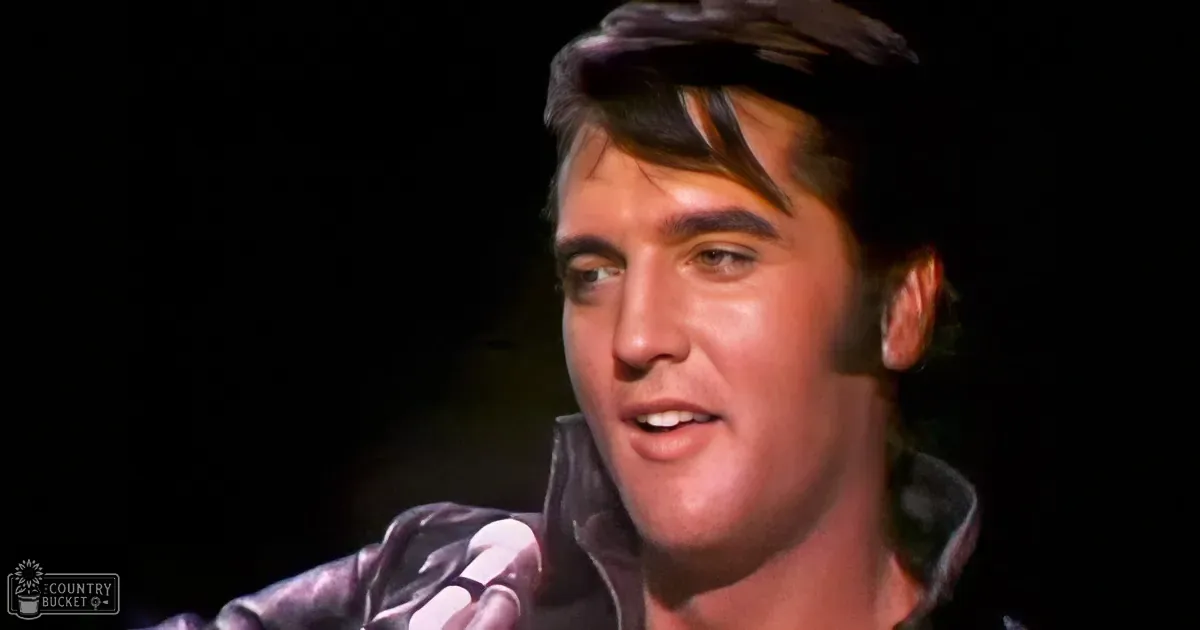 Elvis Presley singing into a microphone, wearing a black jacket, with a dark background.
