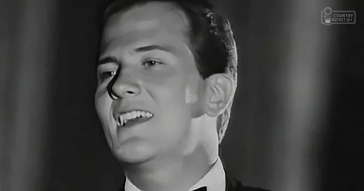 A man in a suit smiles with a unique, possibly edited, appearance.