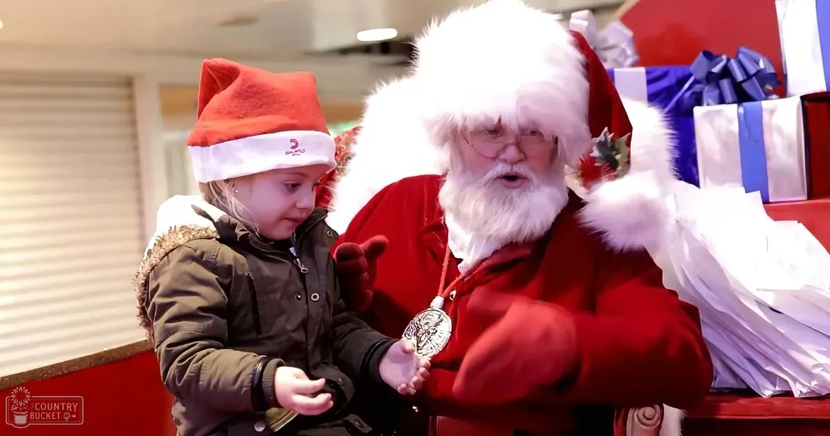 A man dressed as Santa Claus sits in a car with another festive individual beside him, both wearing holiday-themed attire.